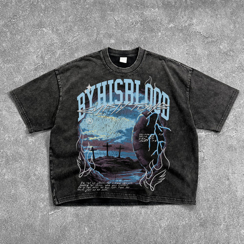 Black t-shirt with graphic design and text on a gray surface